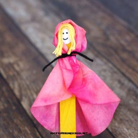 Example of Little Red Riding Hood craft made with coffee filter, markers, yarn, and paper.