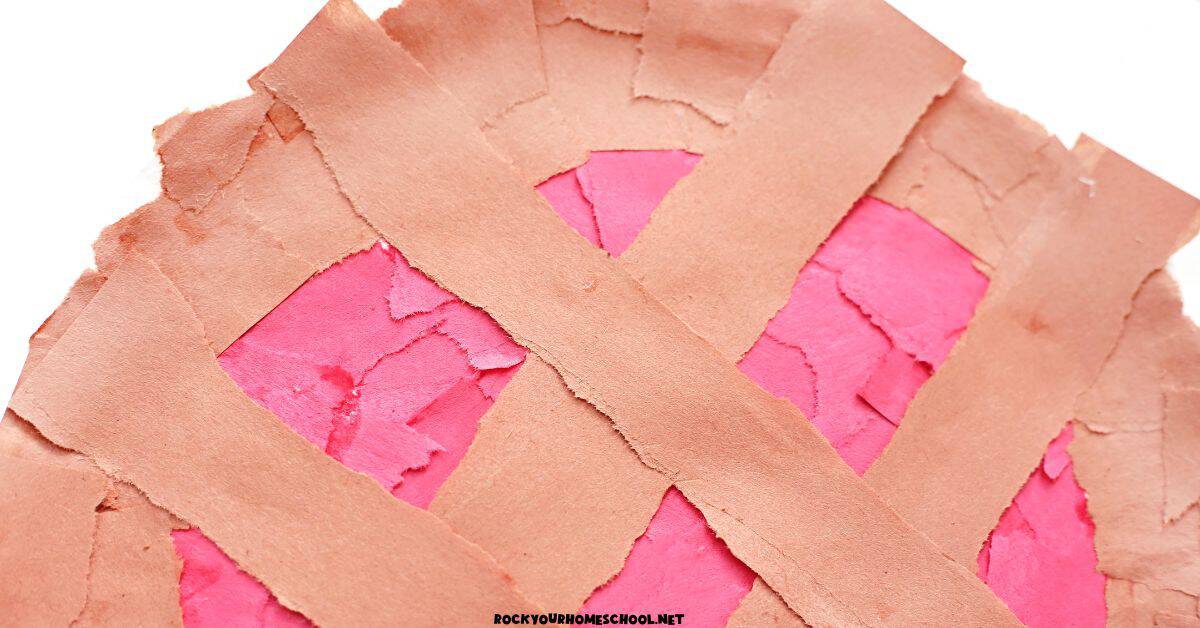 Close-up of apple pie craft with torn paper pieces.