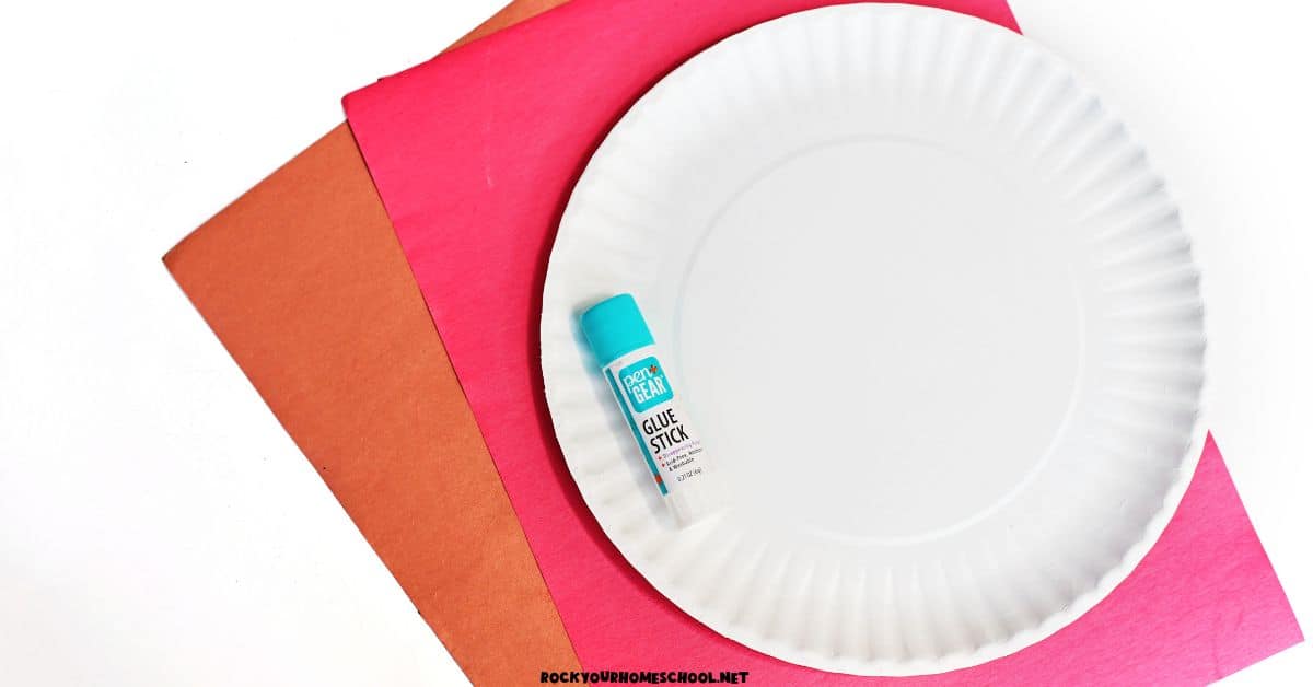 Paper plate, red and brown paper, and glue stick.