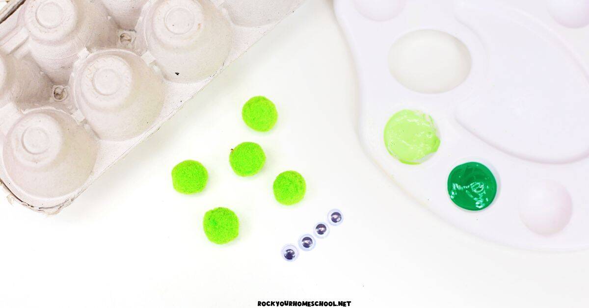 Egg carton, 5 green pom poms, googly eyes, and green paints.