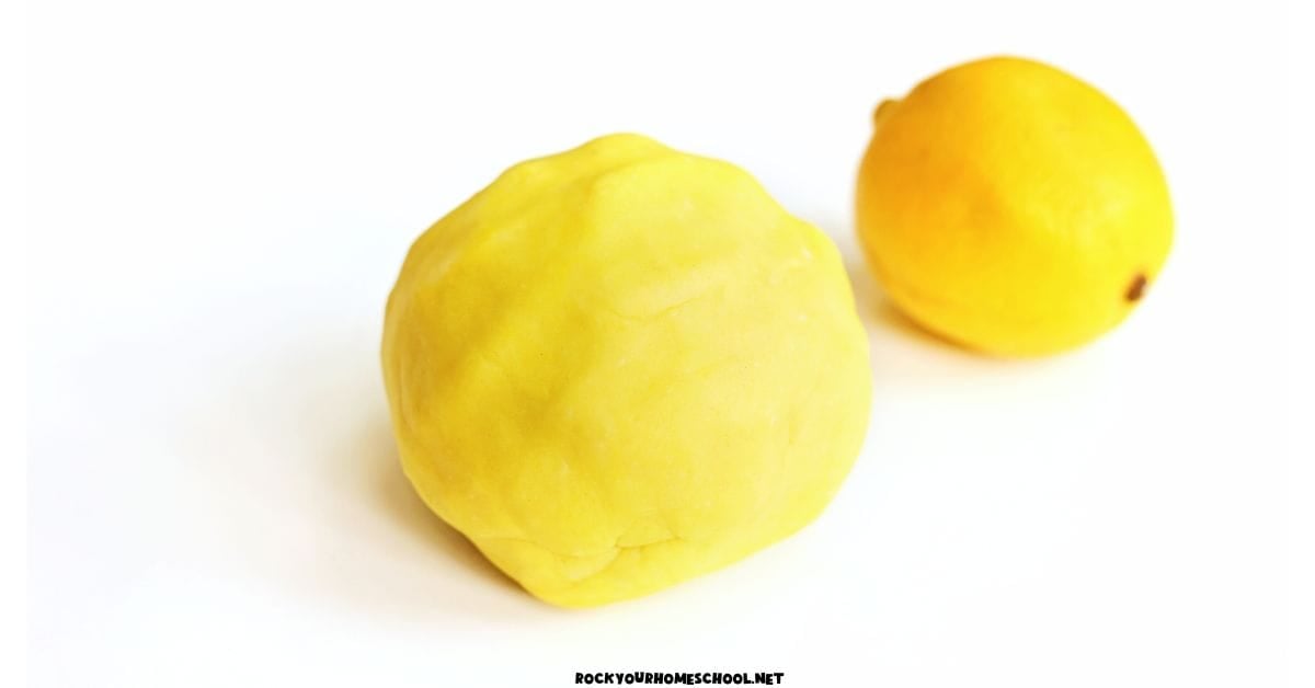 Ball of yellow lemon playdough with lemon.
