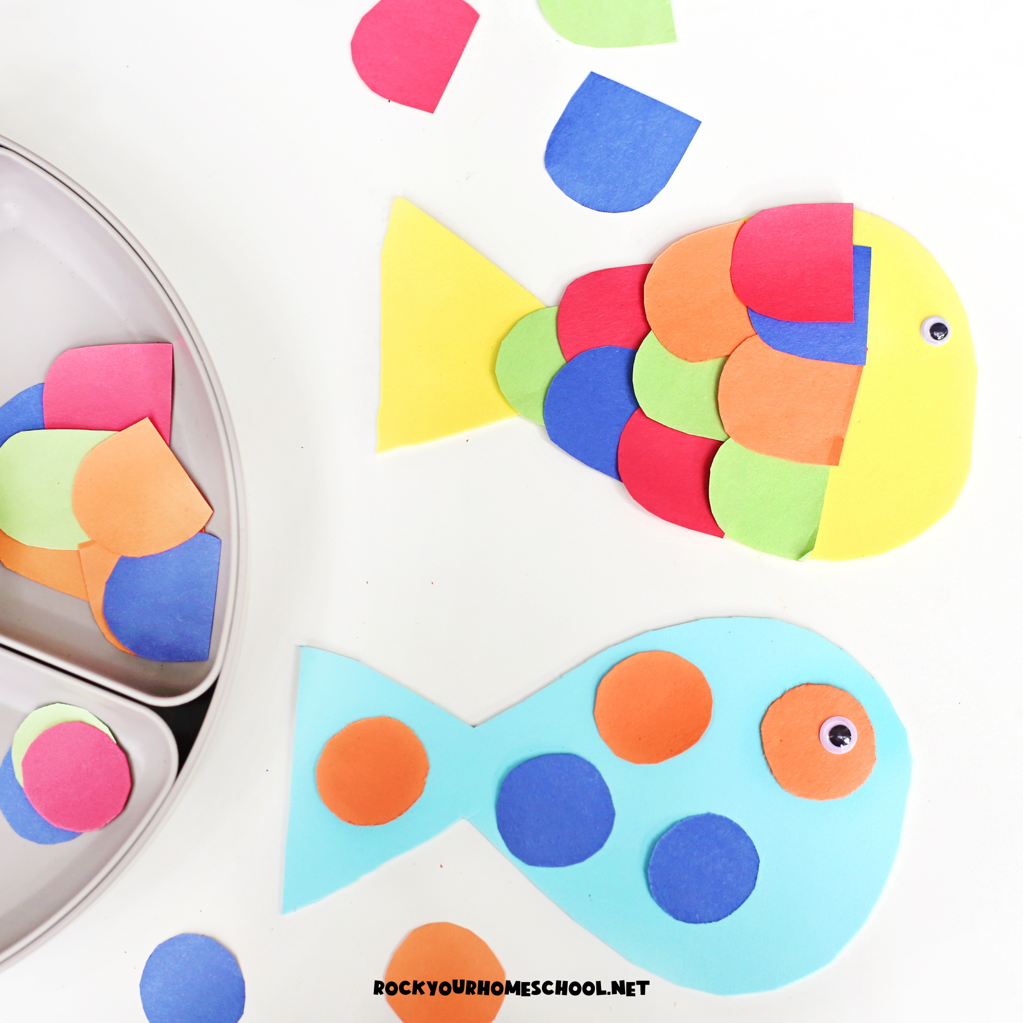 Two examples of paper fish craft made using activity tray with colorful paper pieces.