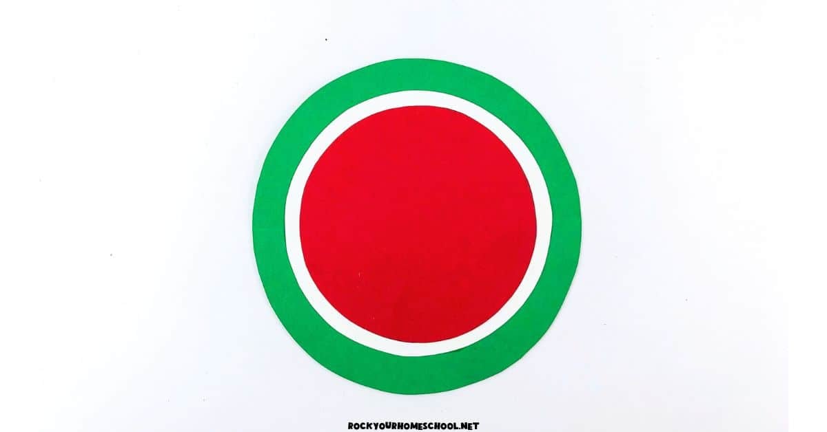 Green paper circle with white and red circle in middle.