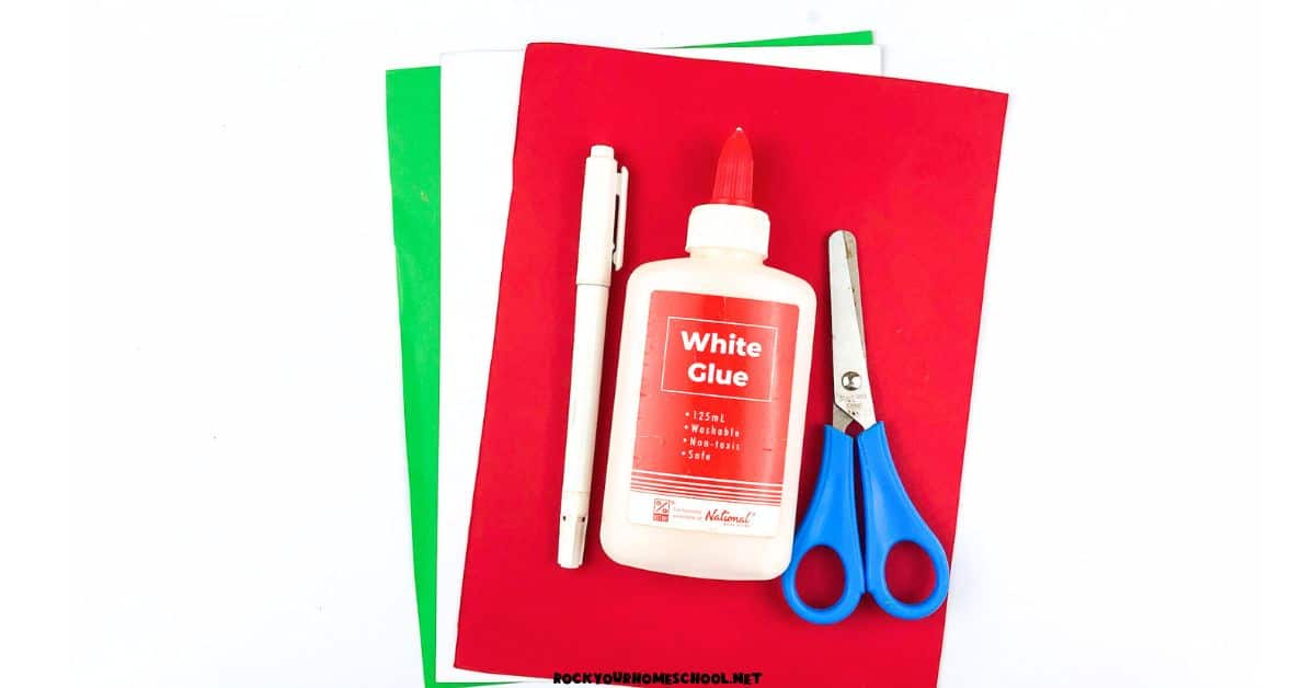 Green, white, and red paper with marker, blue, and scissors.