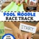 Green pool noodle, craft knife, scissors, paper straw, tape, and white paper and boys using toy car and marbles on DIY pool noodle race track.