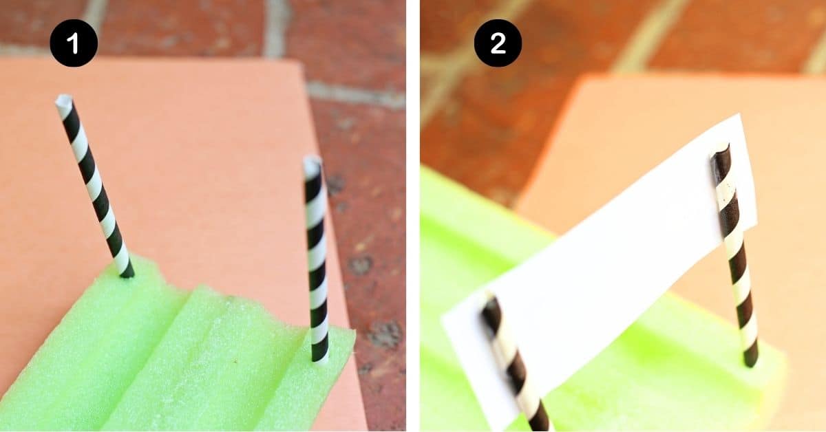 Black and whit paper straws sticking out of green pool noodle cut in half with white paper.