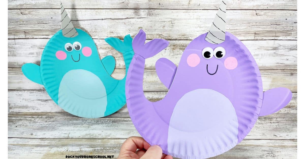 Woman holding examples of cute narwhal crafts for kids.