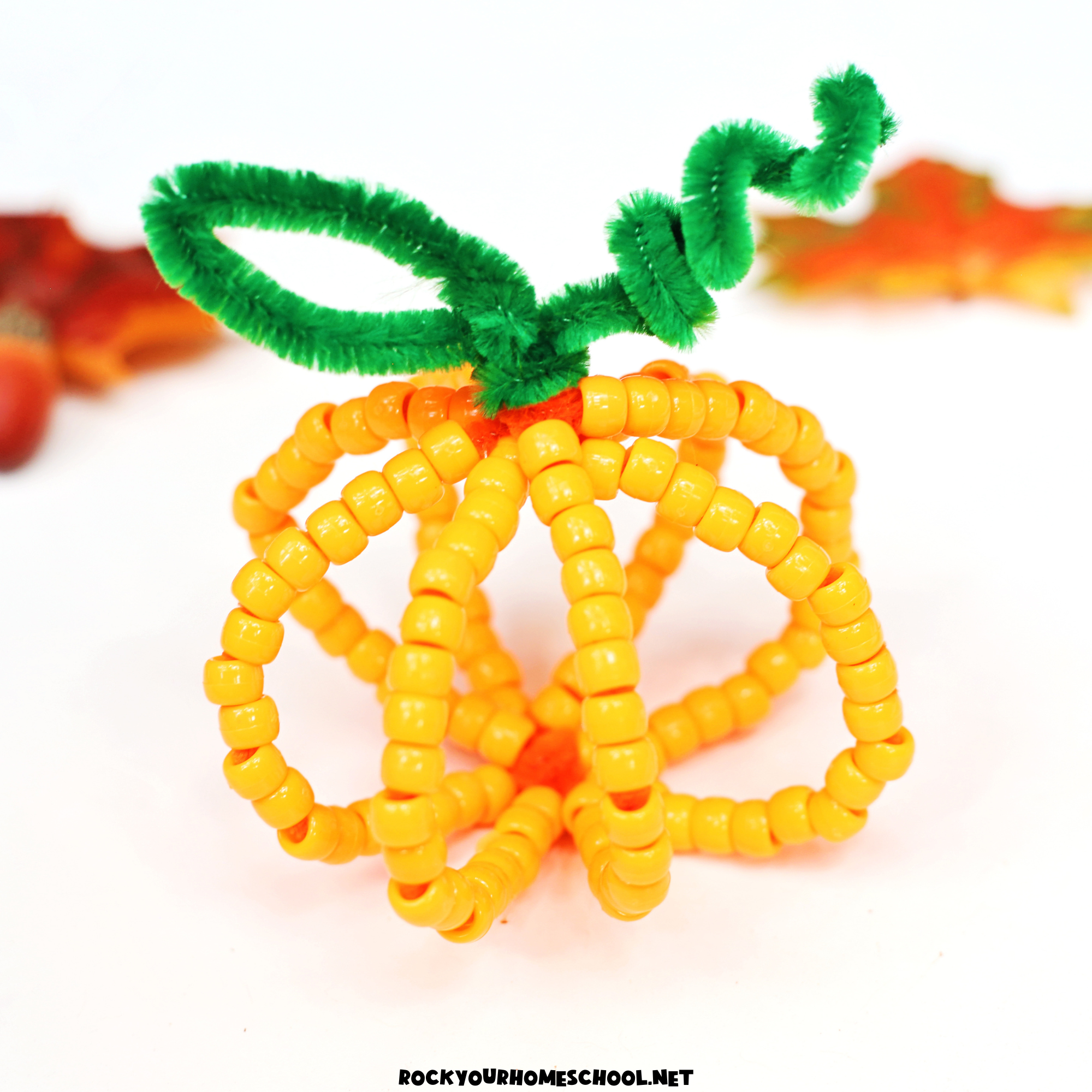 Example of orange beaded pipe cleaner pumpkin craft.