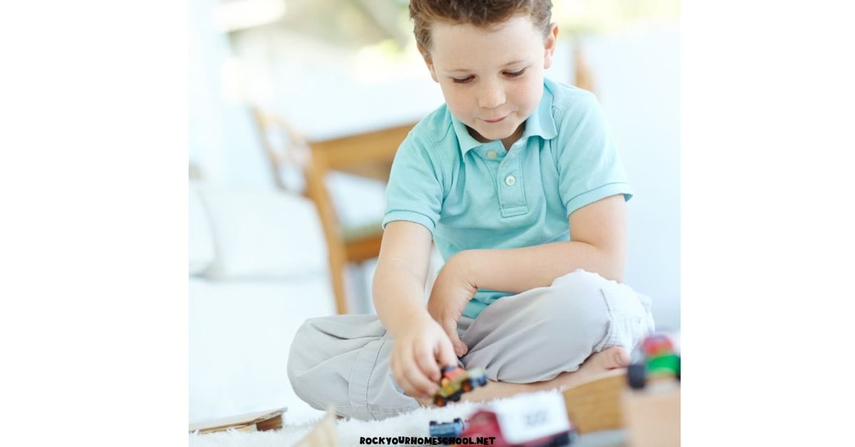 Young boy playing with toy cards for quiet time activity.