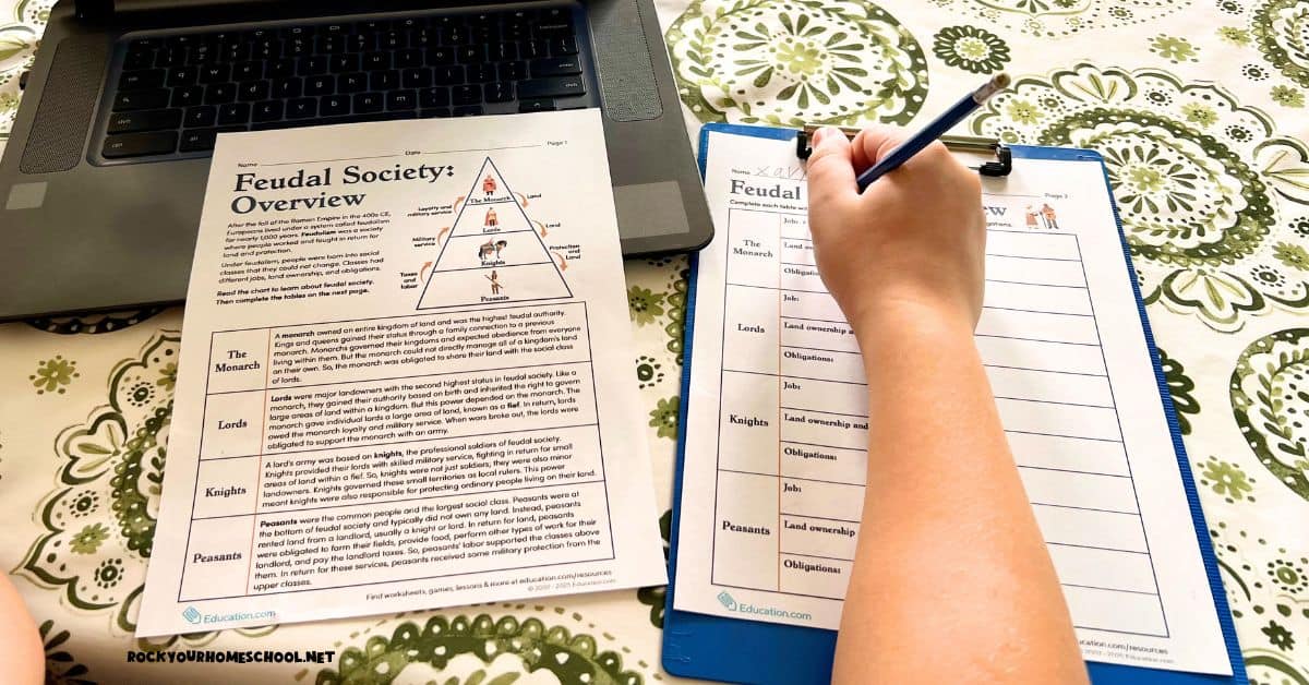 Sixth grader working on Feudal Society worksheets for social studies.