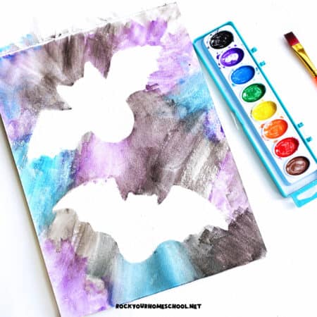 Example of simple bat silhouette craft made with watercolor paint, watercolor paper, and free printable bat template.