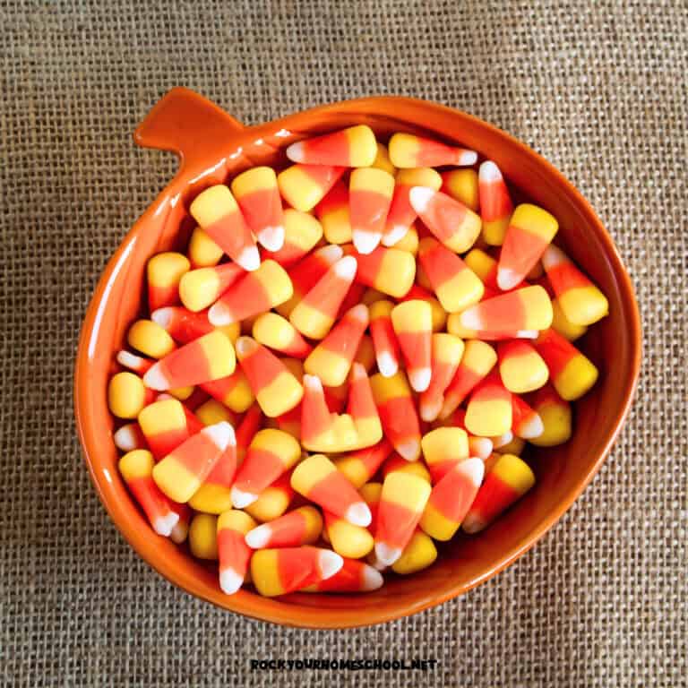 Pumpkin bowl of candy corn on burlap to feature these candy corn activities for kids.