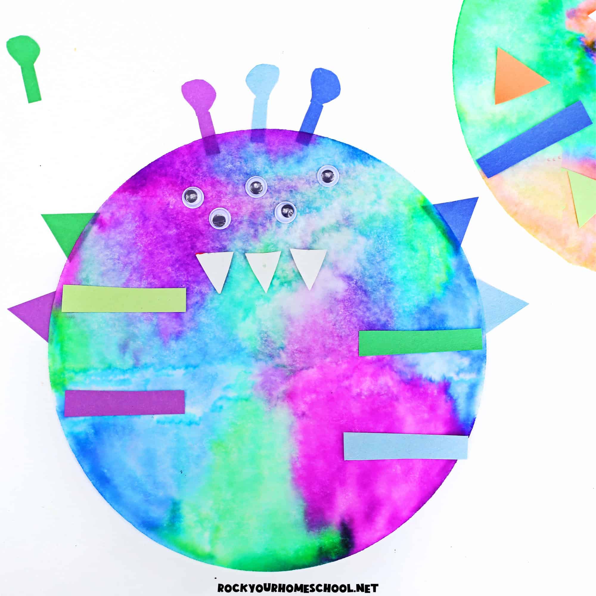 Example of colorful coffee filter monster craft for kids with googly eyes.
