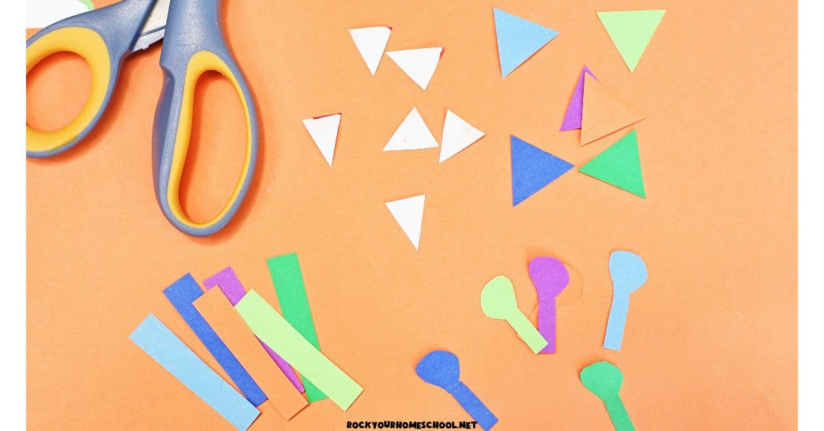 Construction paper pieces of triangles, rectangles, and other shapes with scissors. 