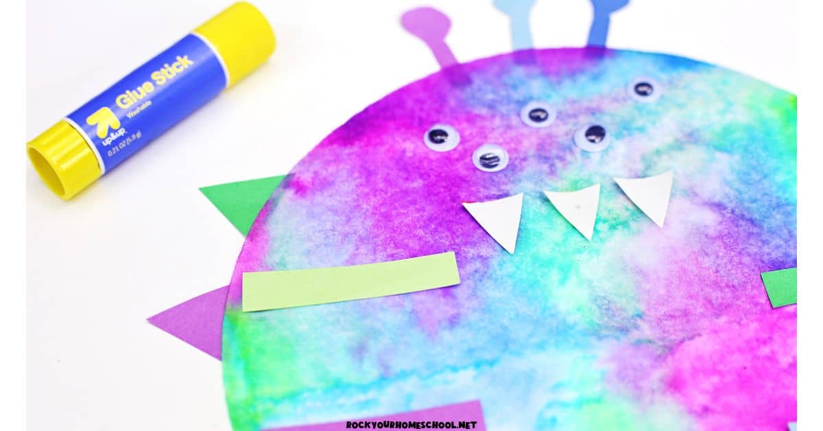 Coffee filter colored purple, blue, and green with construction paper pieces, googly eyes, and glue stick