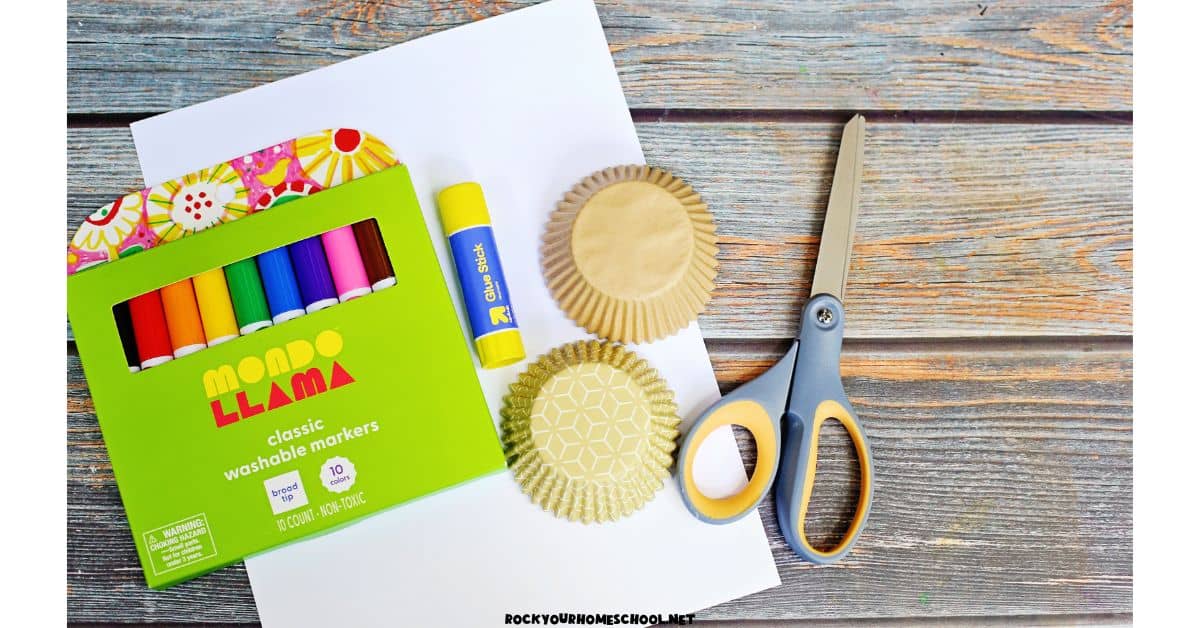 Light brown cupcake liners, scissors, glue stick, and markers.