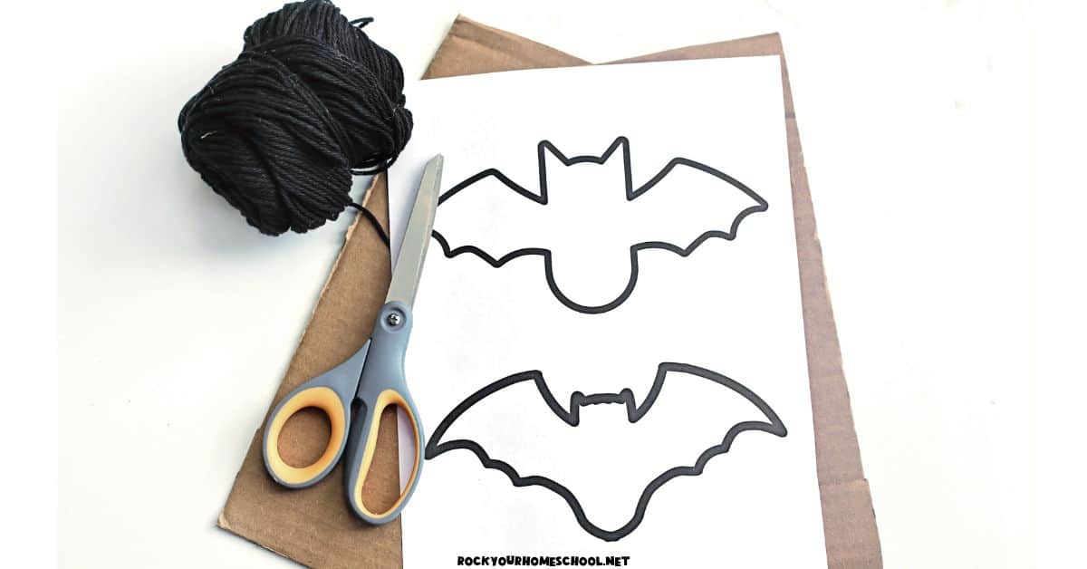 Black yarn, cardboard, scissors, and free printable bat template.