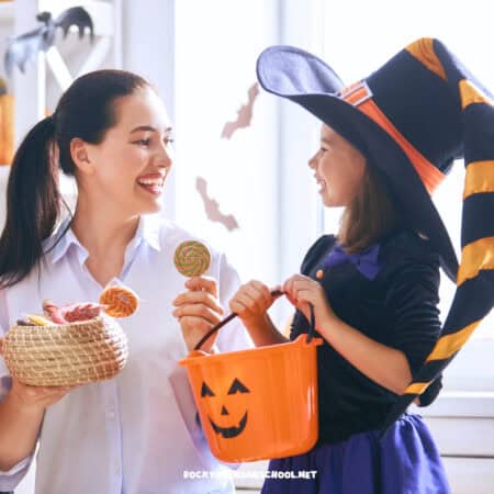 Smiling mom and daughter in Halloween costume to feature these stress-free Halloween fun ideas, activities, and printables for kids.