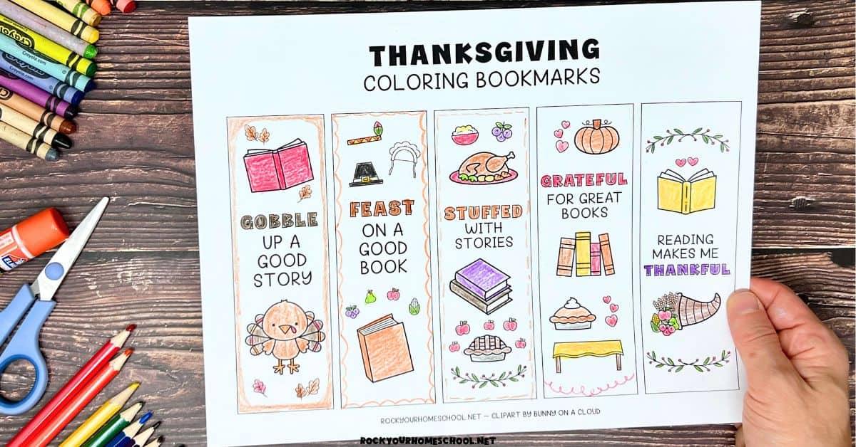 Woman holding free printable page of Thanksgiving coloring bookmarks.