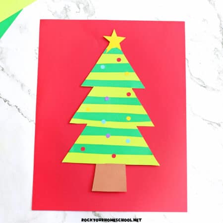 Example of paper strip Christmas tree in greens with colorful paper circle ornaments and yellow star.