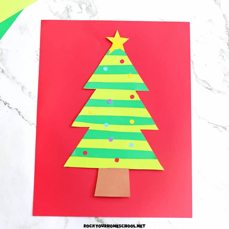 Example of paper strip Christmas tree in greens with colorful paper circle ornaments and yellow star.