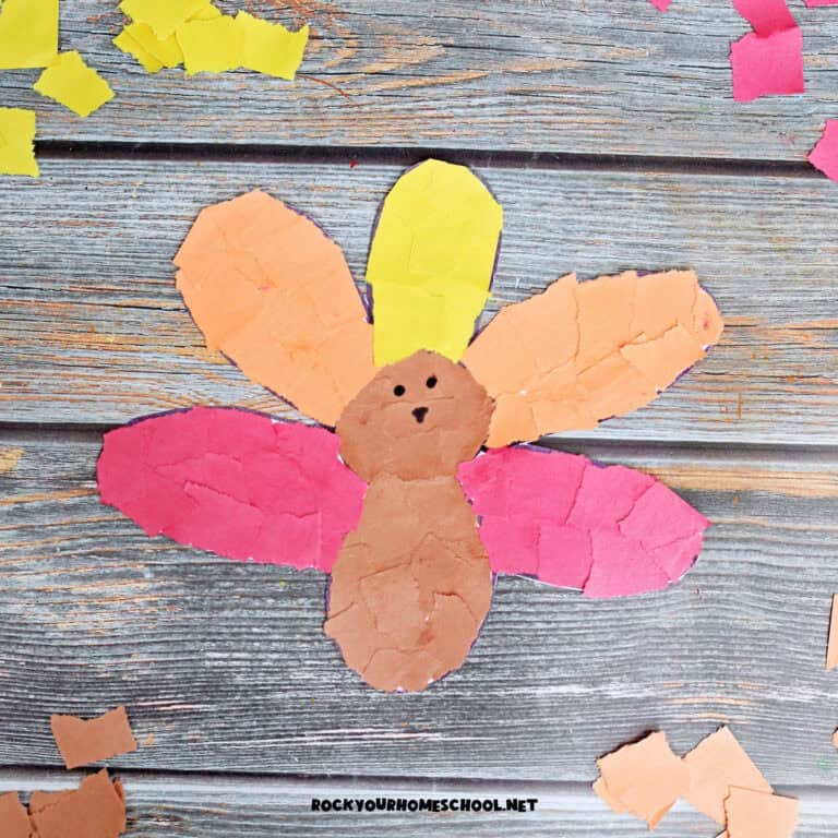 Example of torn paper turkey craft in brown, orange, yellow, and red.