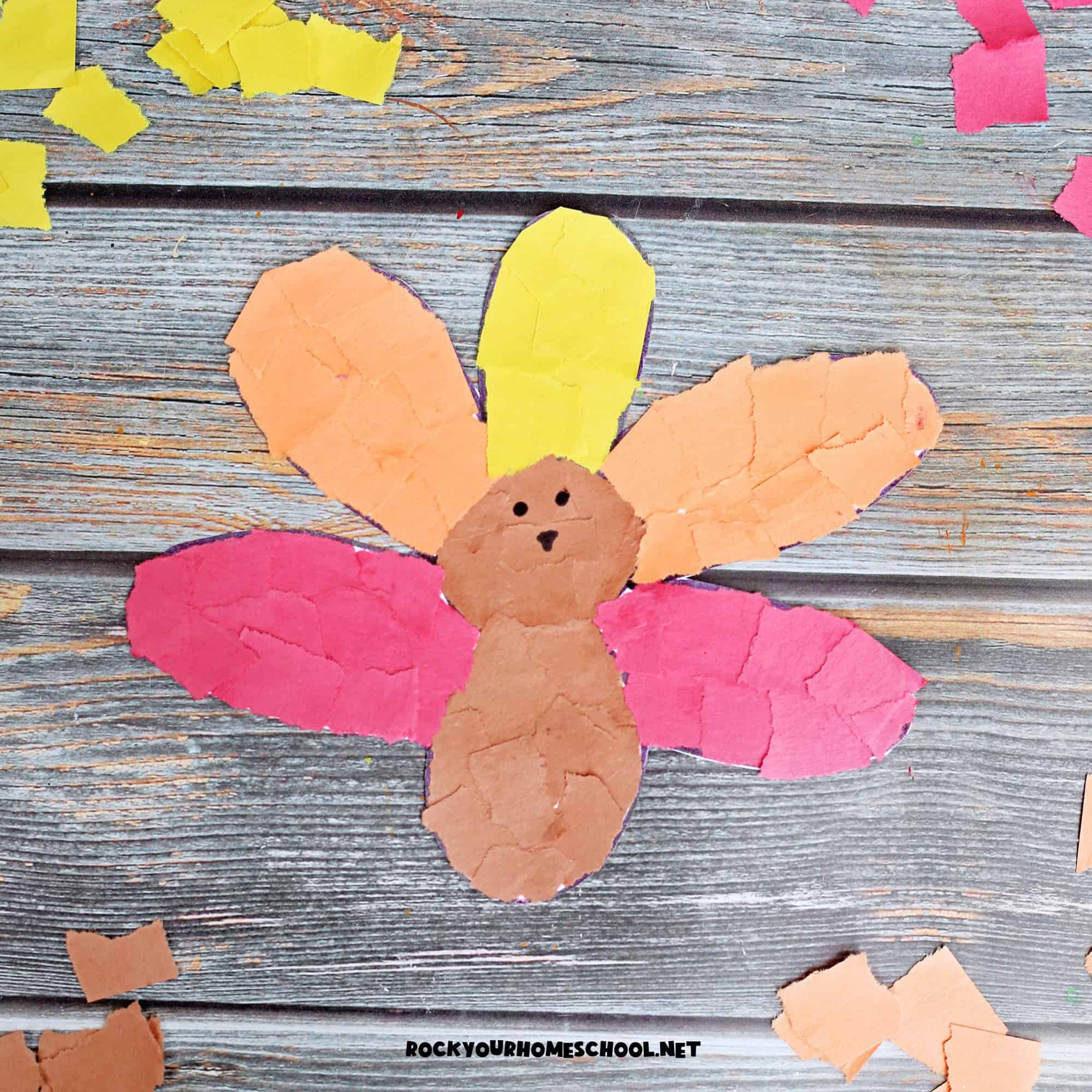 Example of torn paper turkey craft in brown, orange, yellow, and red.