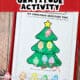 Free printable Christmas gratitude tree activity on red clipboard with Christmas lights on silver ribbon.