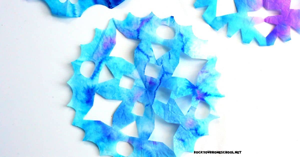 Examples of coffee filter snowflake crafts in blues and purples. 