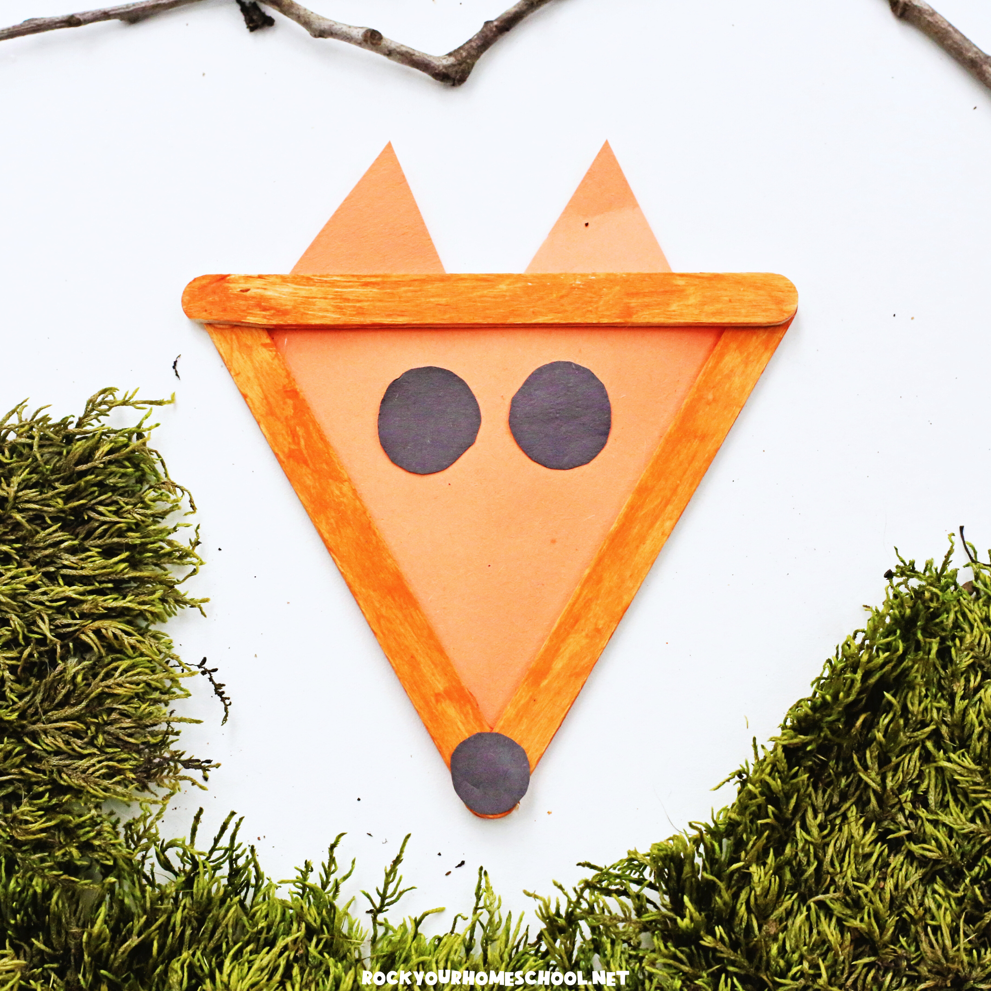 Example of cute fox craft for kids made with popsicle sticks, construction paper, and paint.