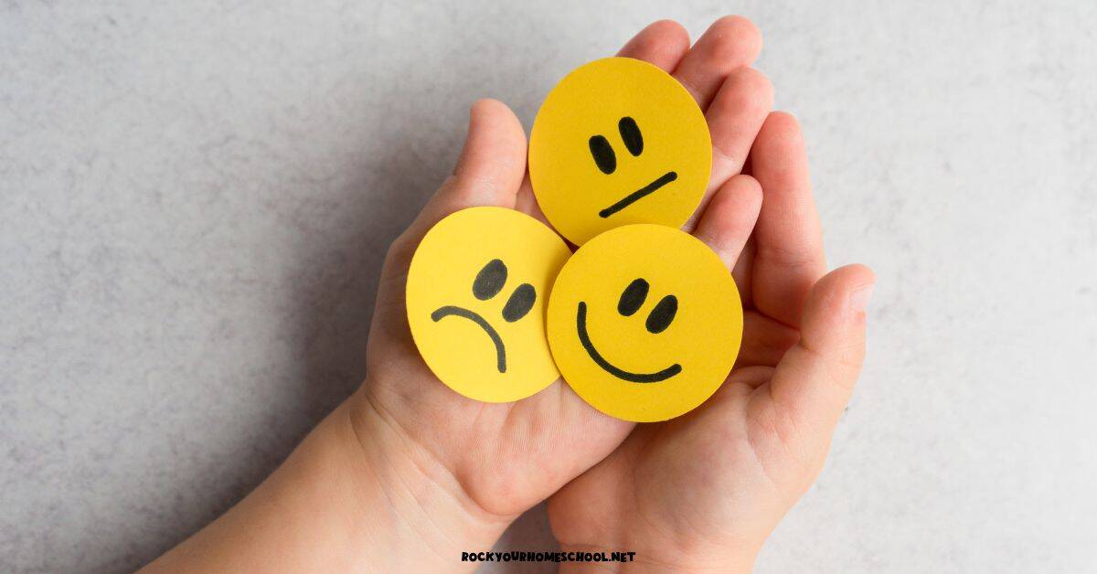 Child holding yellow paper circles with emotional expressions of smile, frown, and confused for SEL activities.