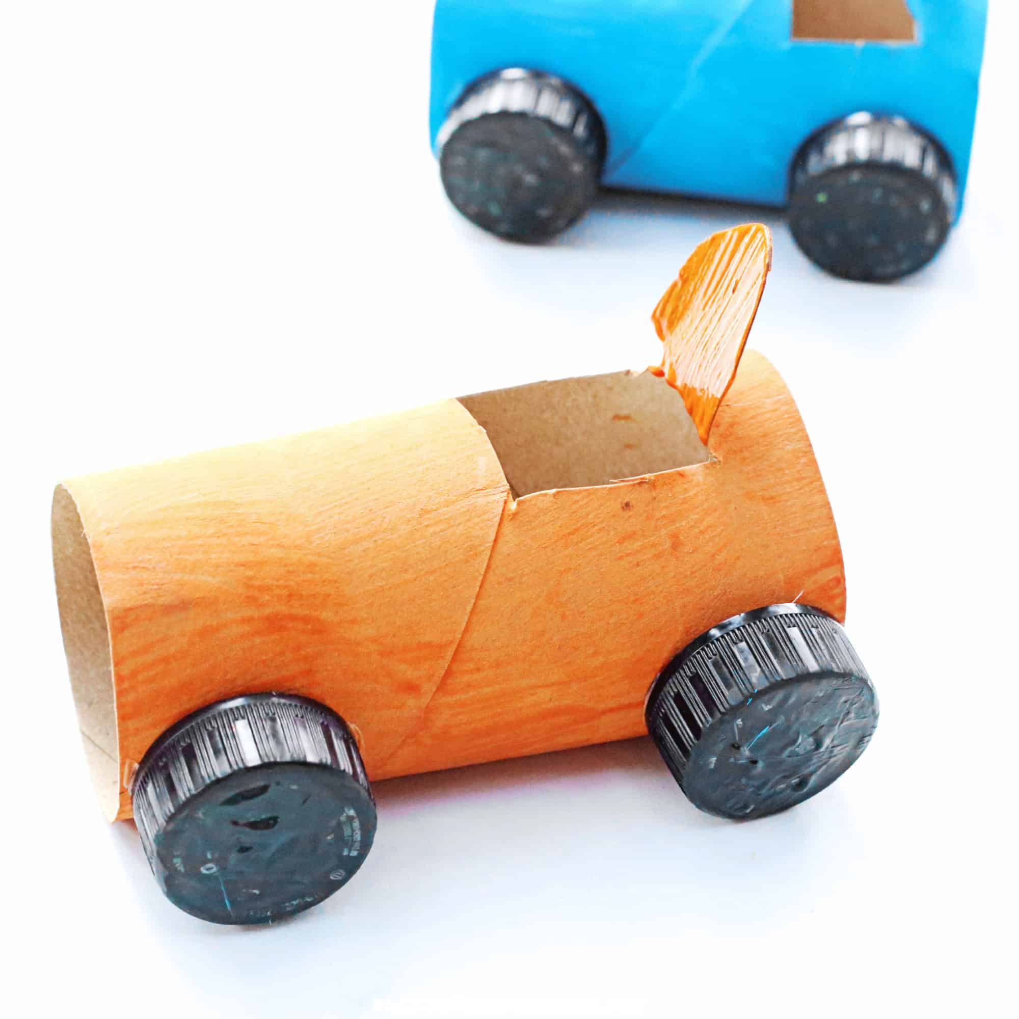 Examples of fun and frugal toilet paper roll car crafts for kids in orange and blue.