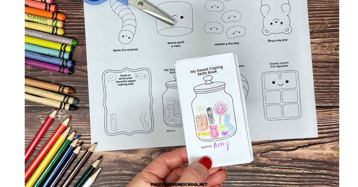 Woman holding example of free printable sweet coping skills mini coloring book.