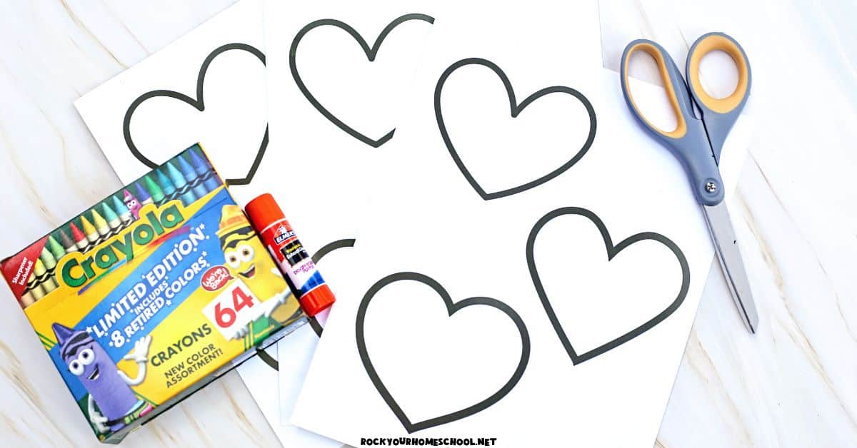 Box of crayons, glue stick, scissors, and paper heart template.