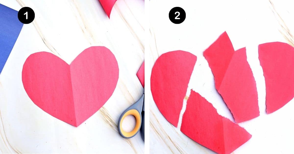 Red paper heart with scissors and torn up into 4 pieces.