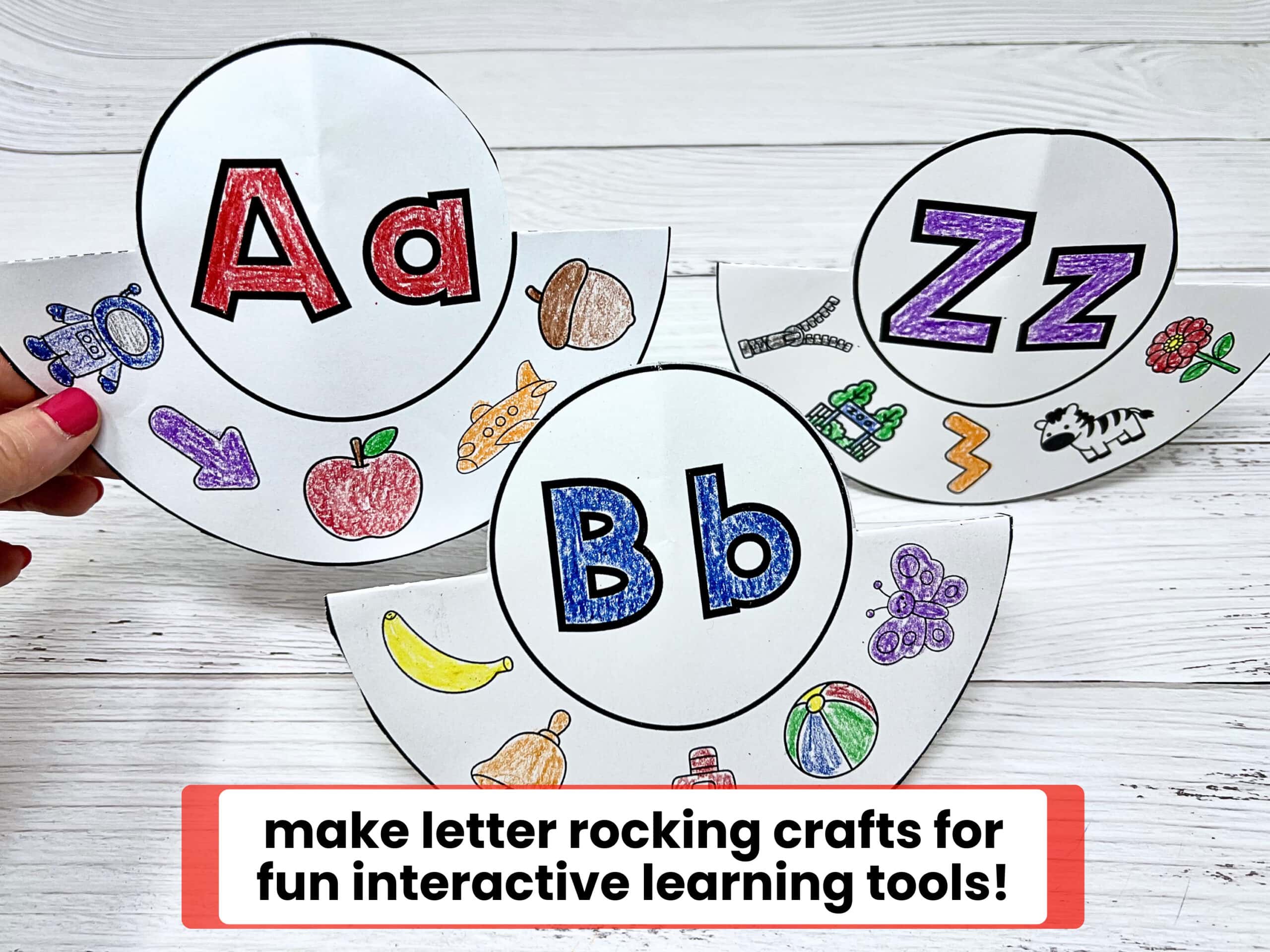 Woman holding examples of printable letter of the week activities for letter rocking crafts of Aa, Bb, and Zz.