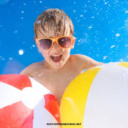 Young boy smiling as he wears sunglasses and holds beach balls to feature preschool summer themes.