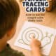 Young boy using his finger to trace a green line of a snail shape to show how finger tracing cards for kids work as calm down tools.